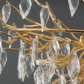 Close-up of a luxurious Albero Collection Crystal Chandelier adorned with elongated clear droplets, intricate branches, and ornate accents against a grey background from Morsale.com.