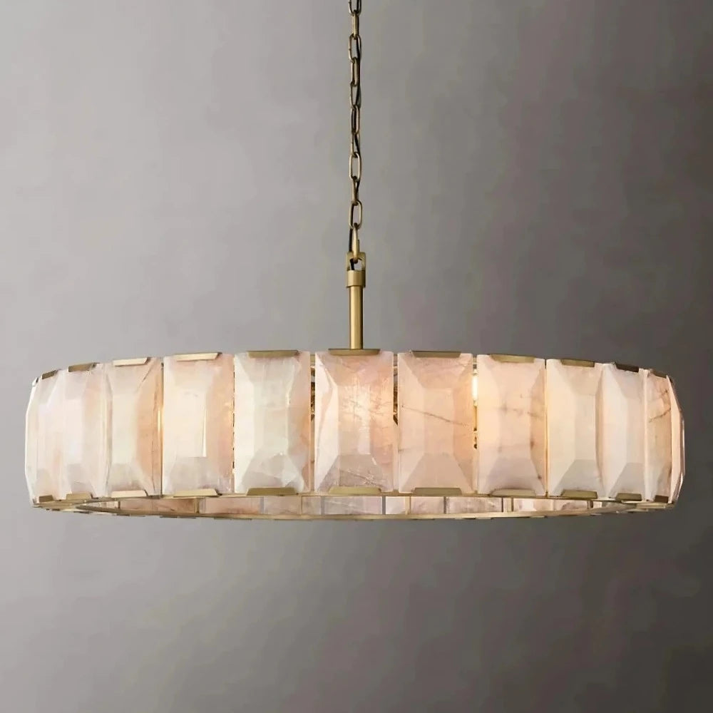 A Villano Calcite Crystal Chandelier by Morsale.com hangs from a chain, featuring a circular design with geometric, faceted white glass panels and a sleek stainless steel frame. The dimmable LED lighting casts a warm glow, highlighting the texture and pattern of the glass.