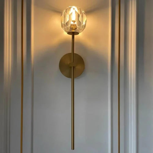 Lucent Crystal Wall Sconce featuring hand-cut glass crystal and solid brass craftsmanship illuminating a stylish interior.