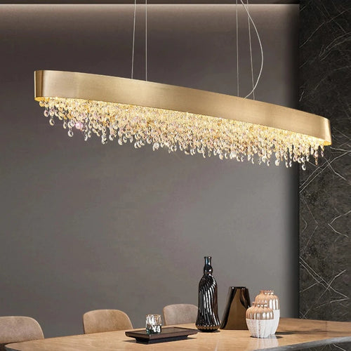 Alleri Modern Crystal Linear Chandelier in Brushed Stainless Steel illuminating a contemporary dining space.
