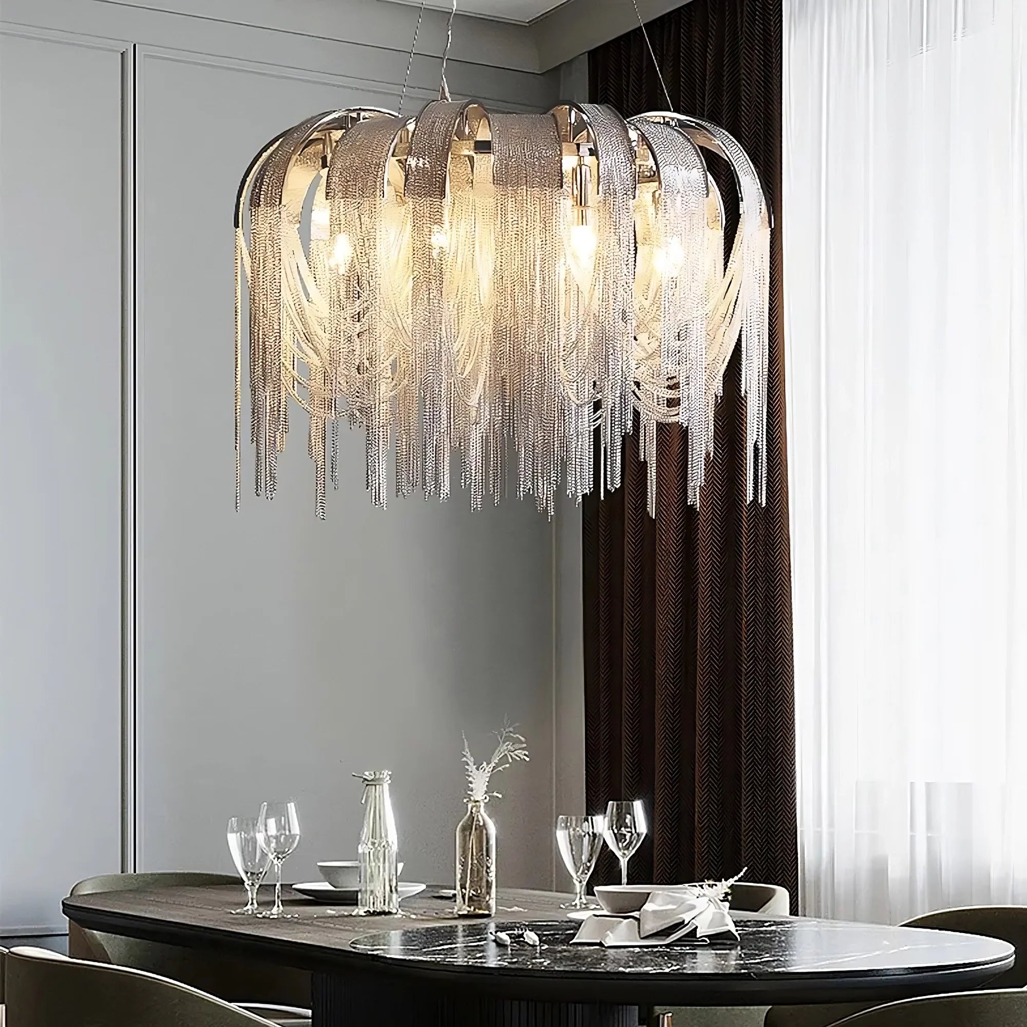 a modern chandelier over a dining table