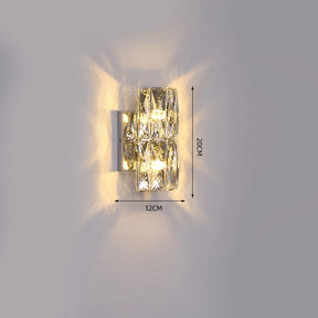 The Bacci Crystal Wall Light Sconce by Morsale.com is a modern wall light fixture adorned with two crystal-like blocks that emit a glowing light. This handmade crystal indoor wall sconce measures 12 cm in width and 20 cm in height, as indicated in the image. Mounted on a plain, light-colored wall, it features LED dimmable technology for adjustable ambiance.