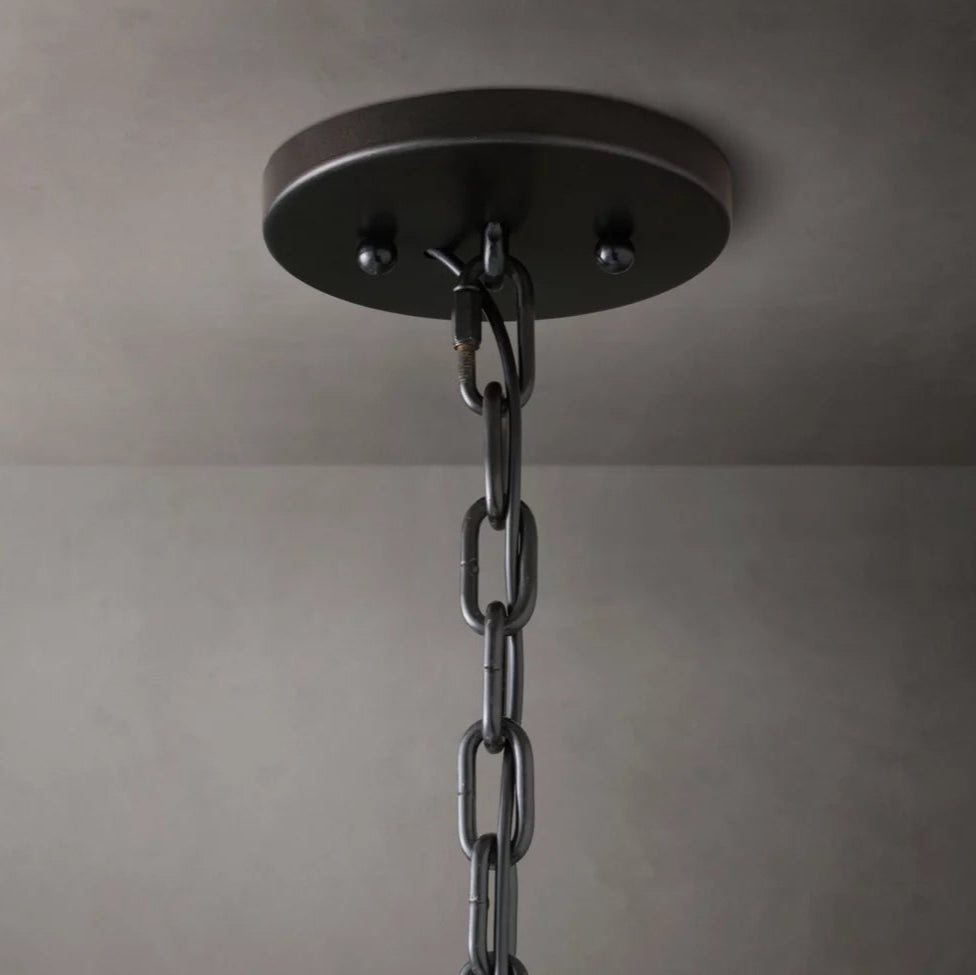 
                  
                    A close-up of the metal chain and round, dark ceiling mount of the Brookhill Calcite Modern Chandelier by Morsale.com against a light ceiling, showcasing its elegant iron frame.
                  
                