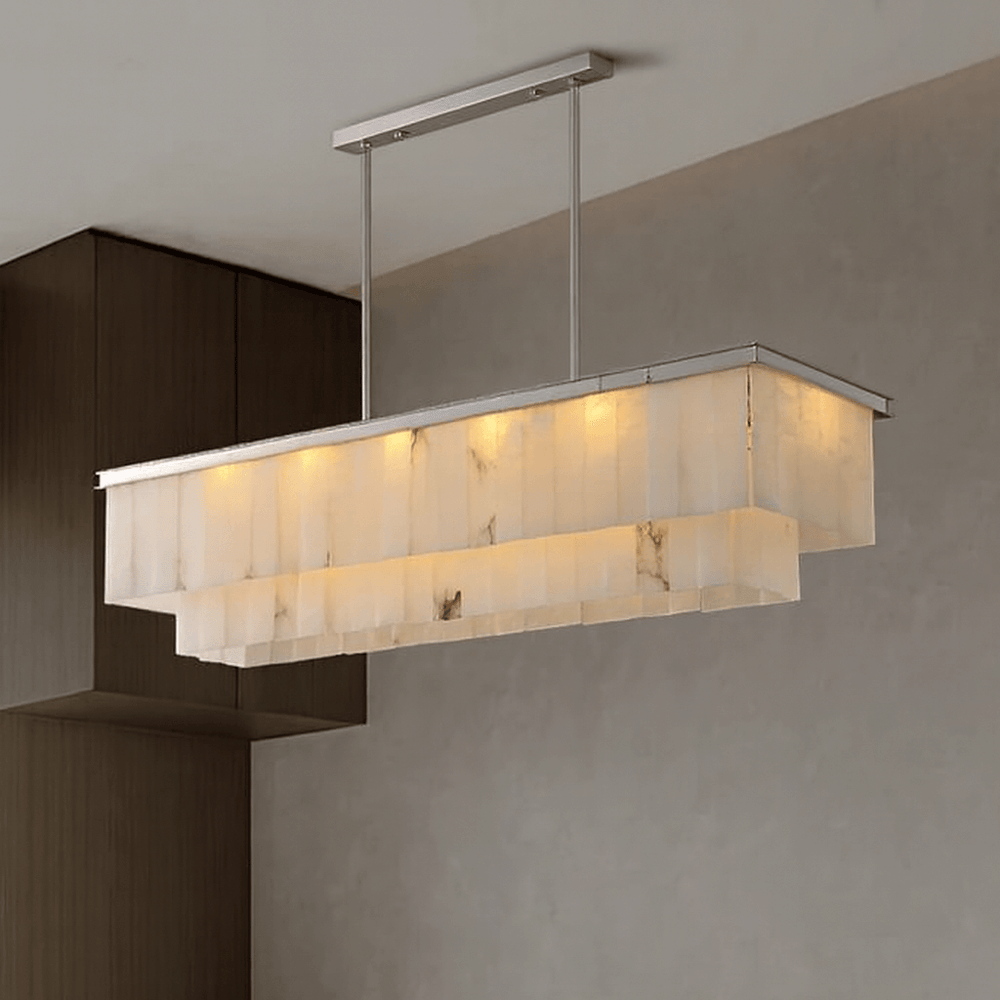 
                  
                    The Windsor Marble Dining Chandelier by Shopp578 features layered Spanish marble shades on a solid brass frame with twin metal rods, creating a warm glow and modern style for any minimalist dining space.
                  
                