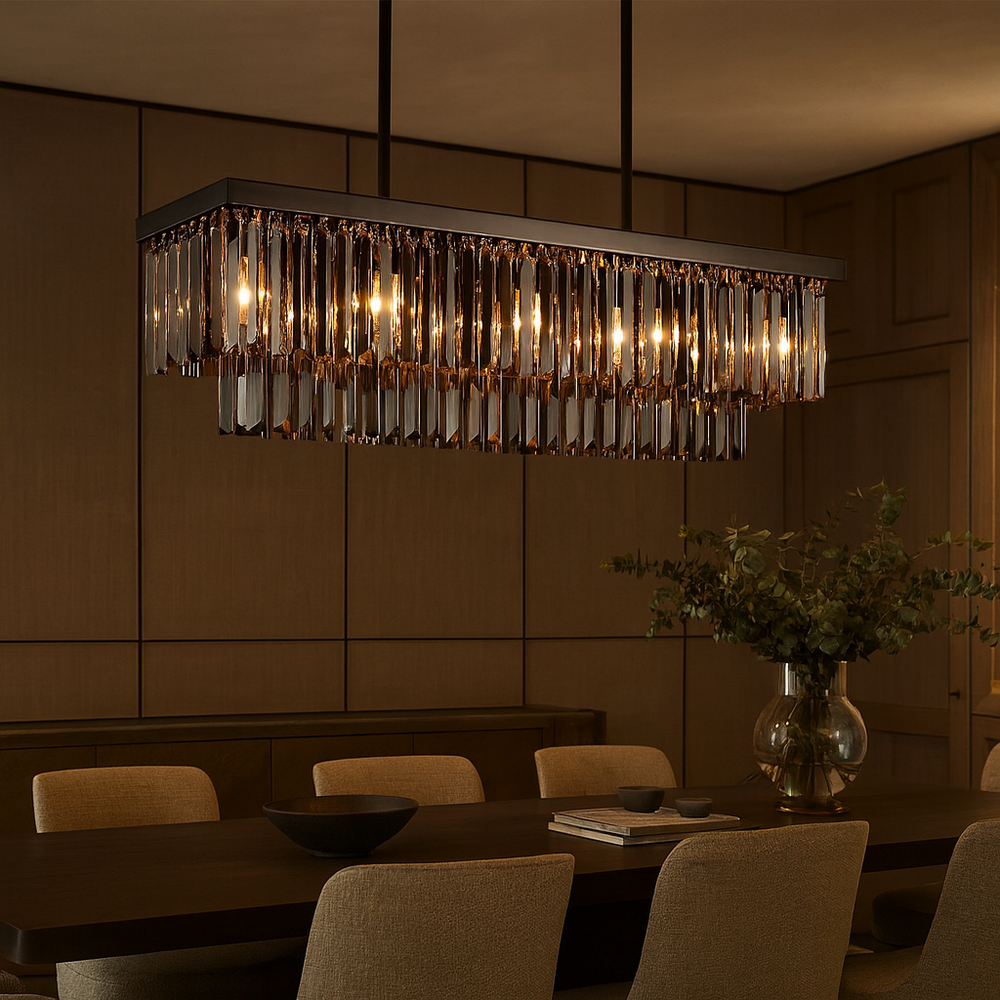 A modern dining room with the Gio Crystal Dining Chandelier from Morsale.com, featuring hanging crystal accents that softly illuminate a dark wooden table, beige upholstered chairs, and a vase with greenery.