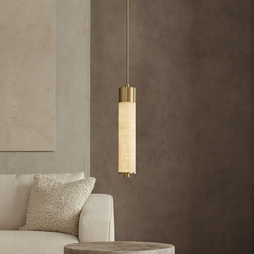 
                  
                    A modern interior showcases the Sorella Marble Pendant from Morsale.com, featuring cylindrical gold and frosted glass, hanging beside a cream textured pillow on a light-colored sofa against taupe walls.
                  
                