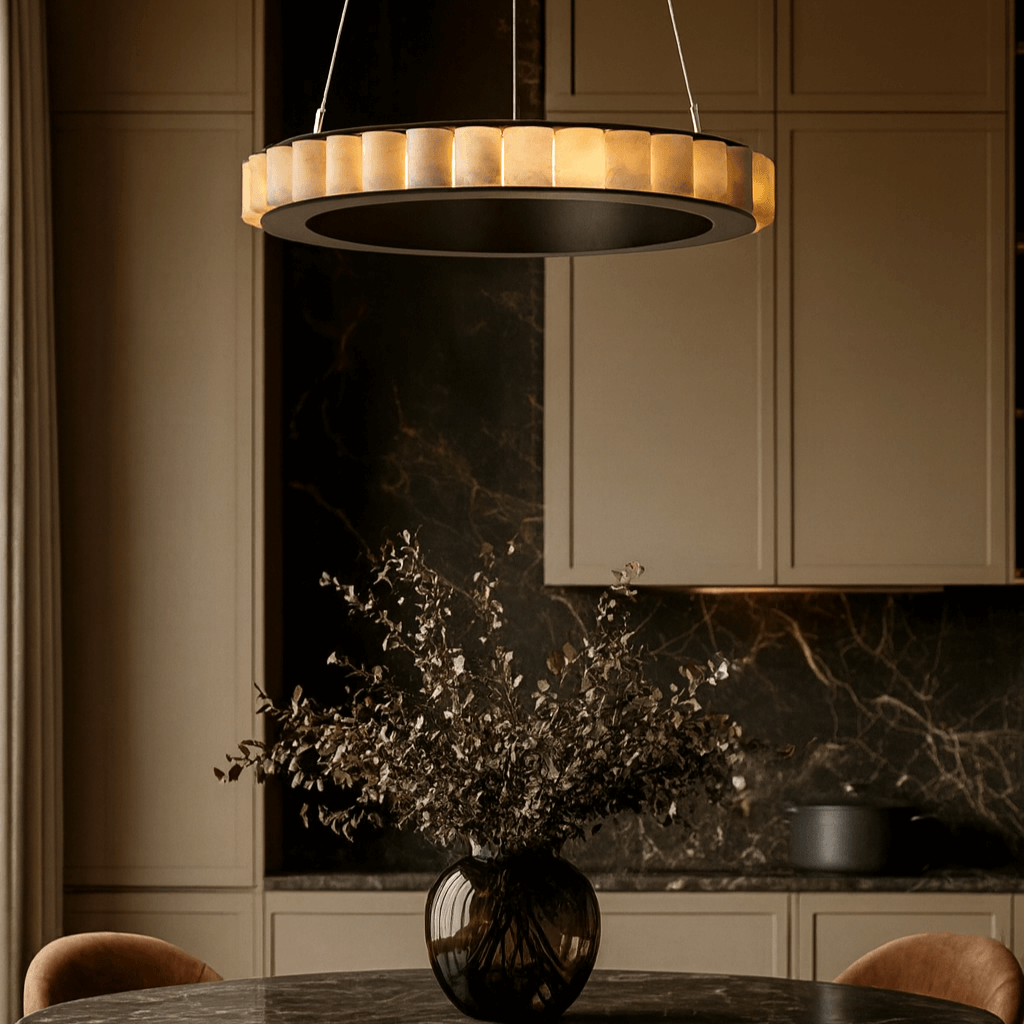 Modern kitchen with a round dining table, chairs, and a hanging light fixture.