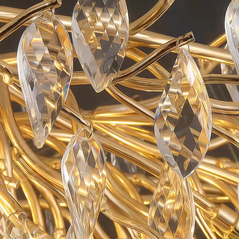 Close-up of the Albero Collection Crystal Ceiling Light Fixture by Morsale.com featuring crystal-like pendants shaped like elongated leaves. The pendants hang from golden branches with adjustable hanging wire, creating an intricate and reflective pattern. The overall look is luxurious and ornate.