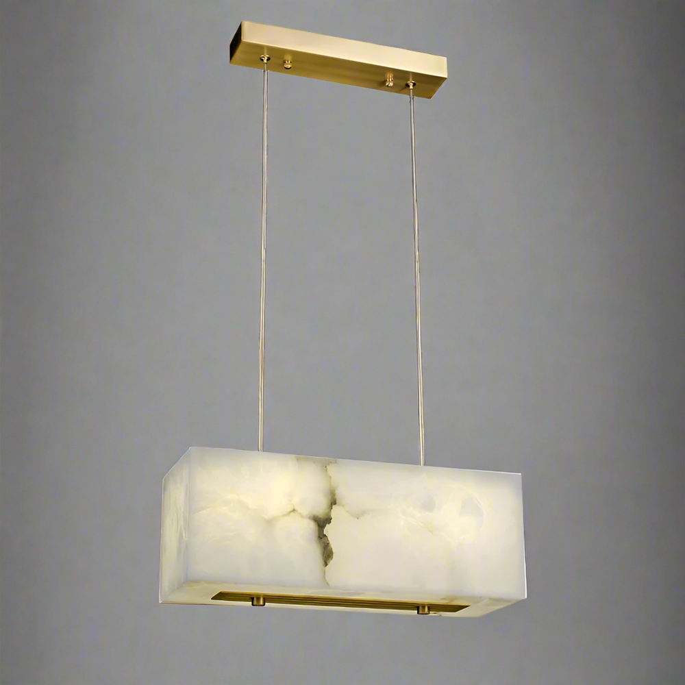 
                  
                    The Leroy Marble Chandelier by Shopp578 features a cloudy white, marble-like rectangular shade suspended by two slim wires from a brass ceiling mount, set against a plain gray background.
                  
                