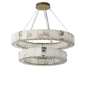 A luxurious chandelier featuring two concentric circular rings, the Natural Marble & Crystal Modern Ceiling Light Fixture by Morsale.com is adorned with vertically arranged rectangular pieces that resemble natural marble and clear crystals. The rings are suspended from a gold-colored ceiling plate by thin cables, perfect for luxury home décor.