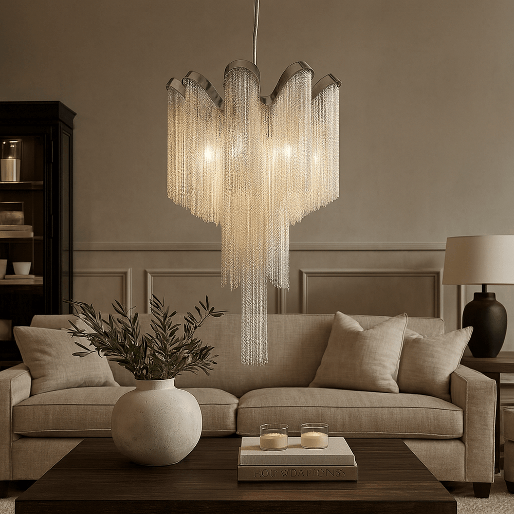 A modern living room with a beige sofa, wooden coffee table, and the Cadena French Empire Chandelier by Morsale.com as an elegant chain tassel ceiling light fixture.