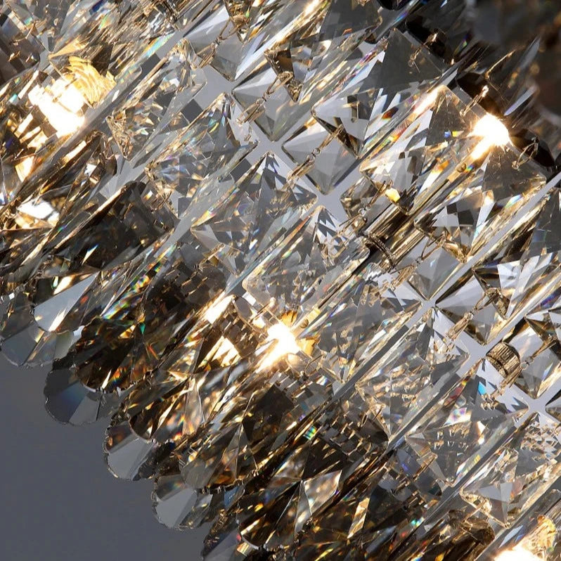A close-up view of the Giano Crystal Ceiling Light from Morsale.com showcasing its intricate and reflective design. The crystals are beautifully illuminated by dimmable LED bulbs, creating a shimmering effect with the light. The image captures the elegance and detail of the chandelier's craftsmanship.
