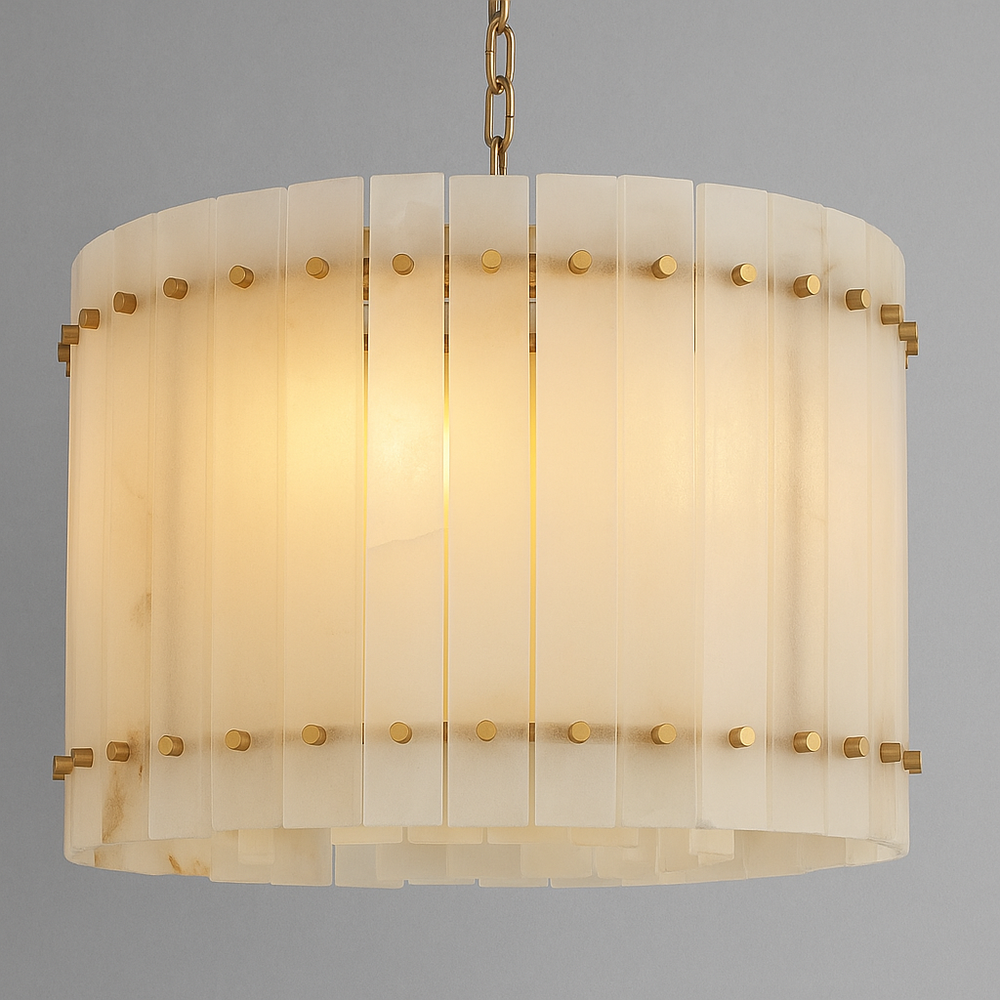 
                  
                    The Valmont Marble Round Chandelier 16" by Morsale features vertical alabaster panels and gold accents, suspended from a gold chain, casting a warm glow against a gray backdrop.
                  
                