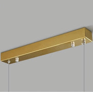A modern ceiling mount from Morsale features a gold-colored rectangular design with durable construction and two suspension cables, set against a plain gray background. The 60" Natural Marble Dining Room Light Fixture's minimalistic, sleek look adds a touch of elegance and sophistication, making it an ideal luxurious design for any dining room.