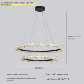 Introducing the Capri 2-Tier Crystal Ring Chandelier by Morsale.com, a modern matte black masterpiece featuring two circular layers, each with an 80 cm diameter, adorned with stunning crystal decorations. This chandelier offers three color light options and is perfect for living rooms, bedrooms, or dining rooms. It’s adjustable to suit your space with a suspension length of up to 120 cm.