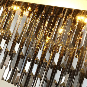 A close-up view of a hanging Gio Smoke Grey Crystal Ceiling Chandelier by Morsale.com with numerous smoke grey crystal prisms. The crystals are illuminated by bright golden lights, creating a radiant and sparkling effect. The prisms are arranged in tiers, reflecting light in various directions, showcasing its elegant design.
