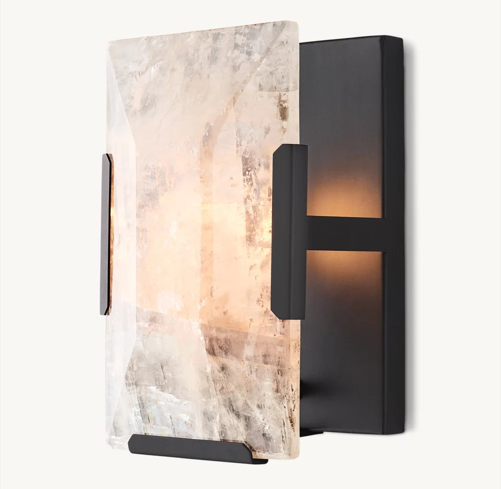 The Brookhill Calcite Crystal Sconce by Morsale.com features a modern black iron frame and a rectangular, stone-like translucent shade, handcrafted to emit a soft, warm glow.