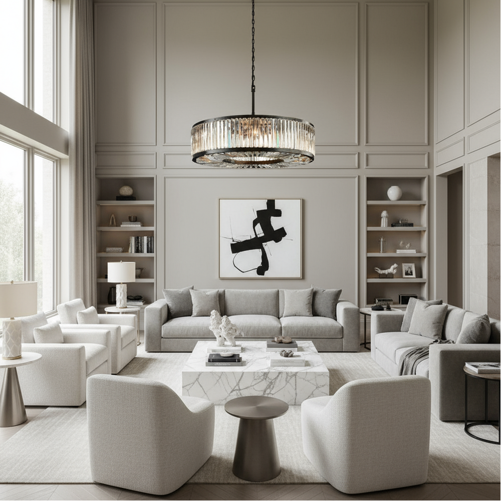 Modern living room with gray sofa, white chairs, and a chandelier.