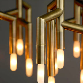 The 48-Light Dining Room Ceiling Light Fixture by Morsale.com boasts a sleek design with multiple vertical brass rods hanging at various lengths, each terminating in small individual G9 LED light bulbs. This contemporary chandelier is elegantly suspended from a rectangular ceiling mount against a plain gray background.