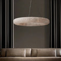 Lucente Modern Crystal Ring Chandelier hanging above a couch in a stylish living room with elegant curtains.