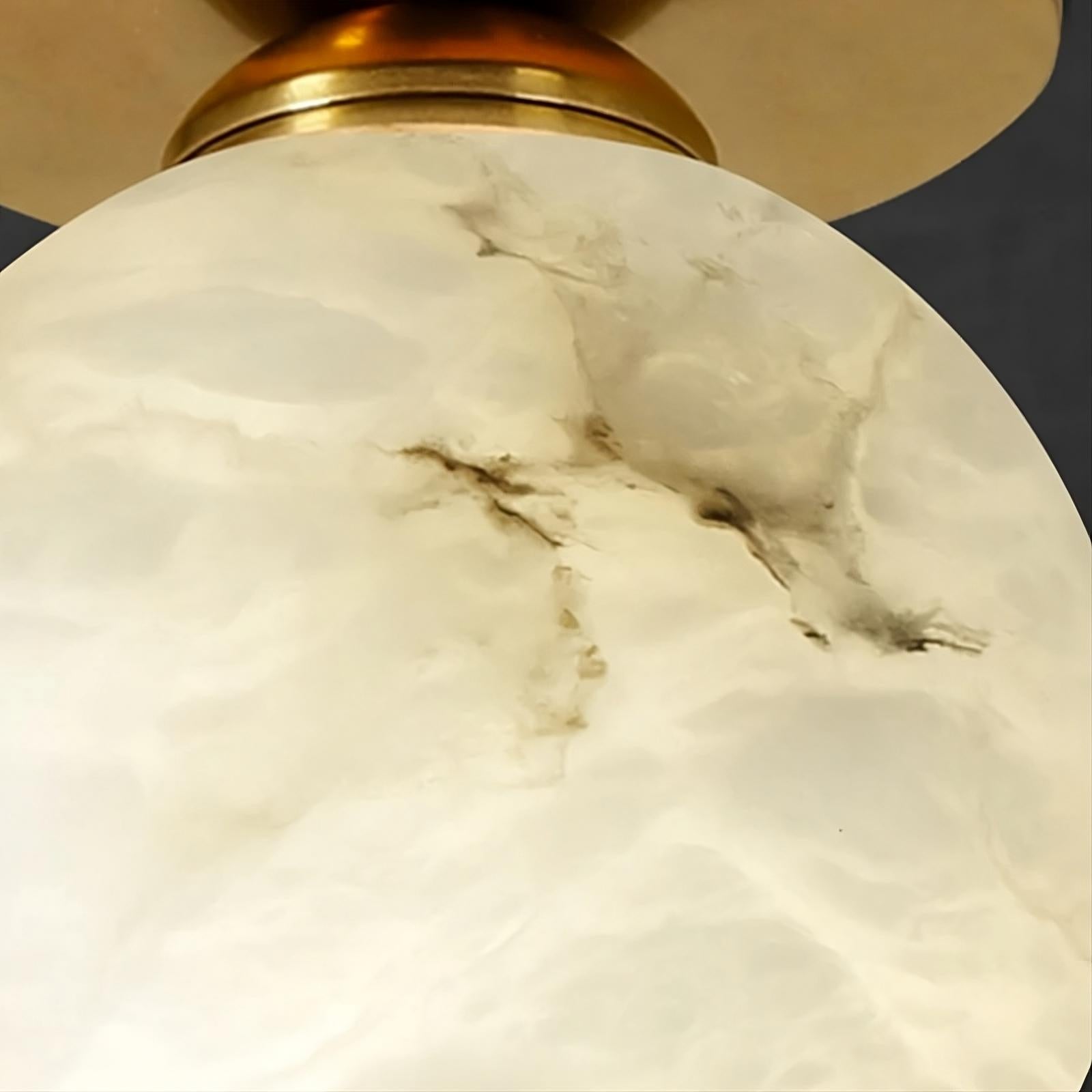 Close-up view of a Natural Marble Hallway Ceiling Light Fixture by Morsale.com with a marble-like white and beige pattern, attached to a brass-colored mounting. The surface texture has intricate, darker vein-like lines, reminiscent of Spanish marble.