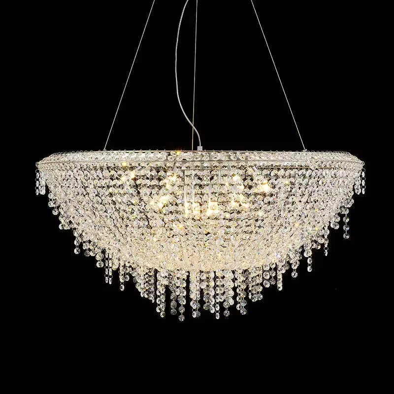 A large, elegant Adena Crystal Tassel Chandelier from Morsale.com adorns the ceiling. This modern chandelier boasts cascading tasseled crystal strands and lights, creating a dazzling, bowl-shaped design that shines brilliantly against a dark background.