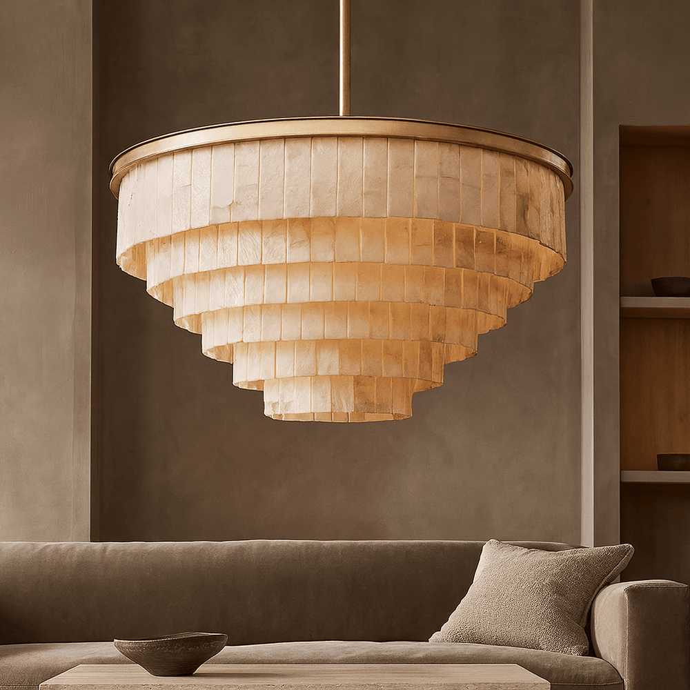 
                  
                    The Berkley Marble Chandelier by Morsale.com hangs above a neutral sofa and cushion in a modern living room with beige walls and built-in shelves, adding warm, textured layers with its large tiered design.
                  
                