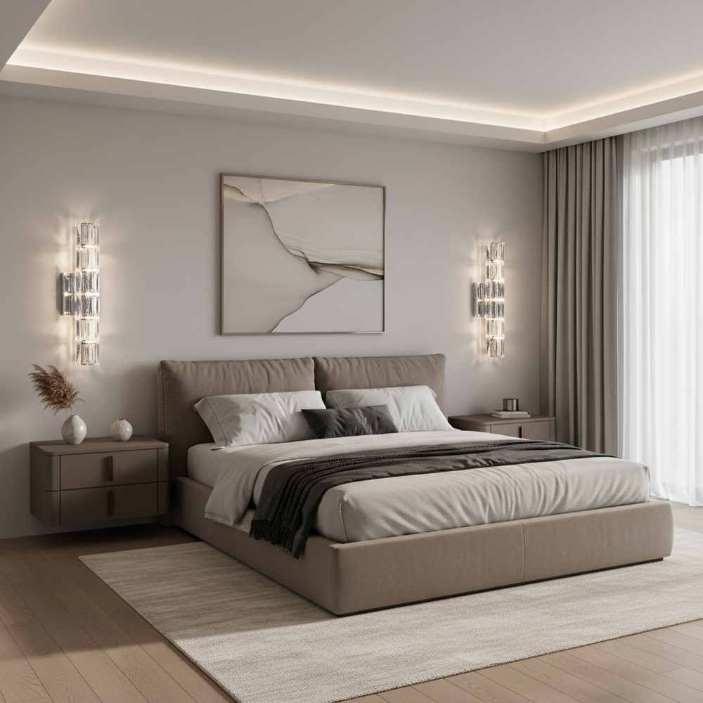 
                  
                    A modern bedroom with a beige upholstered bed, neutral bedding, matching nightstands, the Bacci Crystal Wall Sconce from Morsale.com for elegant lighting, abstract artwork above the bed, large windows with sheer curtains, and minimalist cozy decor.
                  
                