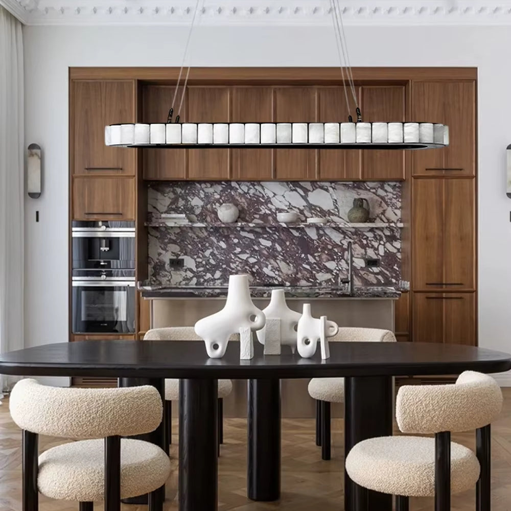 Modern kitchen with wooden cabinets, marble backsplash, and black dining table.