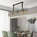 A modern dining room features the Molini Dining Room Chandelier by Morsale.com above a set dining table with stainless steel accents, sheer curtains, elegant chairs, and abstract wall art.