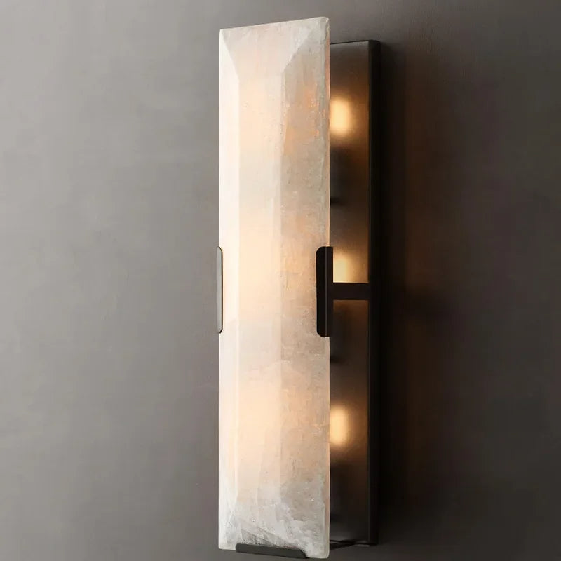 
                  
                    Wall-mounted light fixture with marble-like glass panel on a gray wall
                  
                