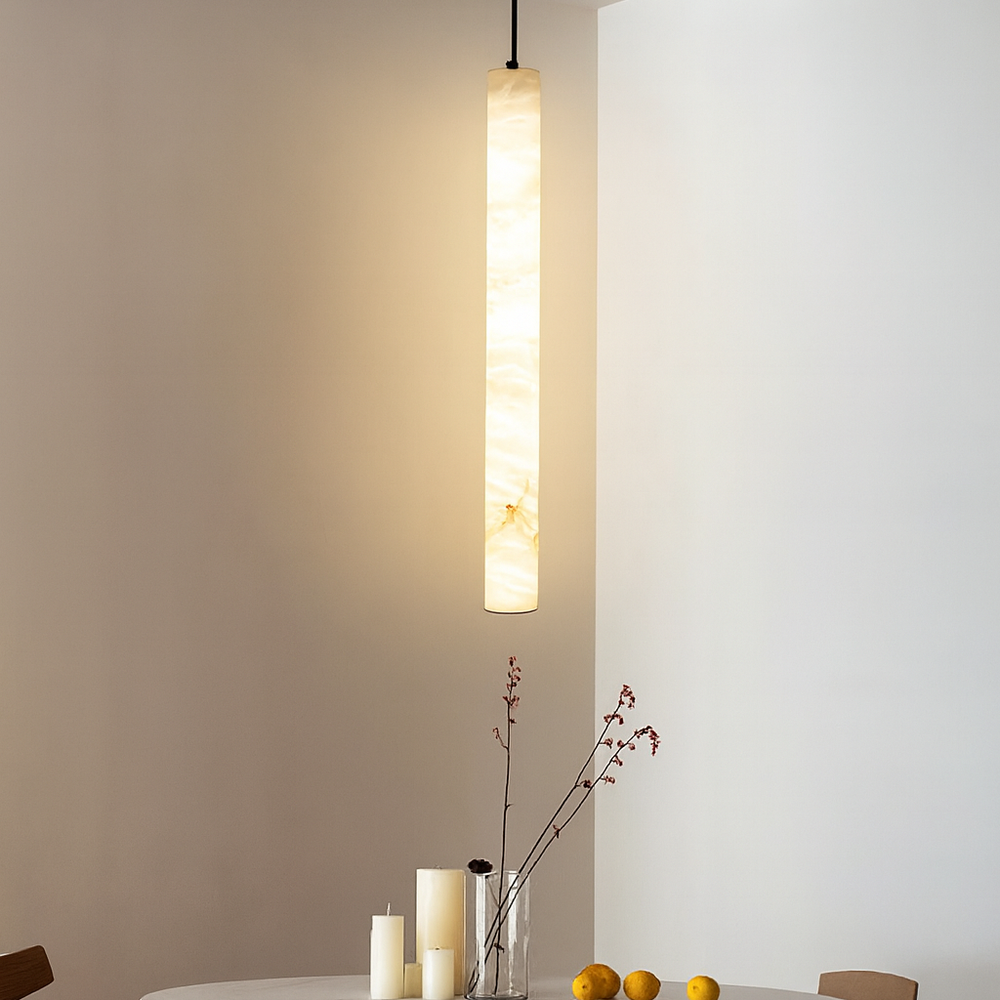 
                  
                    Pendant light fixture hanging above a dining table with candles and fruit.
                  
                