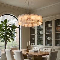 Dining room with a wooden table, chairs, and a chandelier.