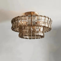 The Riviera Flush Mount by Morsale features wavy, textured glass panels in a circular design around a central bulb on a round base, creating a modern and elegant chandelier ideal for contemporary spaces.