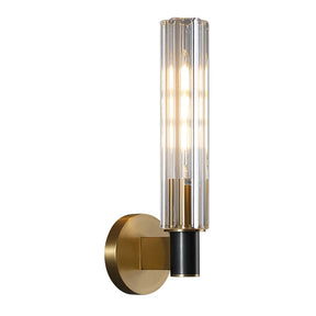 The Morsale Palermo Retro Brass Wall Sconce features a cylindrical, vertically ribbed glass shade encasing a glowing light bulb. The base and mounting plate boast a brass finish, with a black accent where the textured glass globe connects to the fixture.