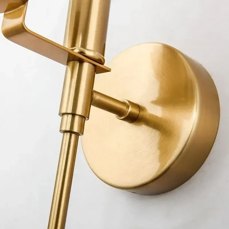 Close-up of the Moonshade Marble Wall Light Sconce by Morsale.com, showcasing its modern brass design. The sconce features a sleek and minimalist cylindrical arm and base, beautifully enhanced by its unique marble texture, set against a plain white background—ideal for elevating any interior decor.