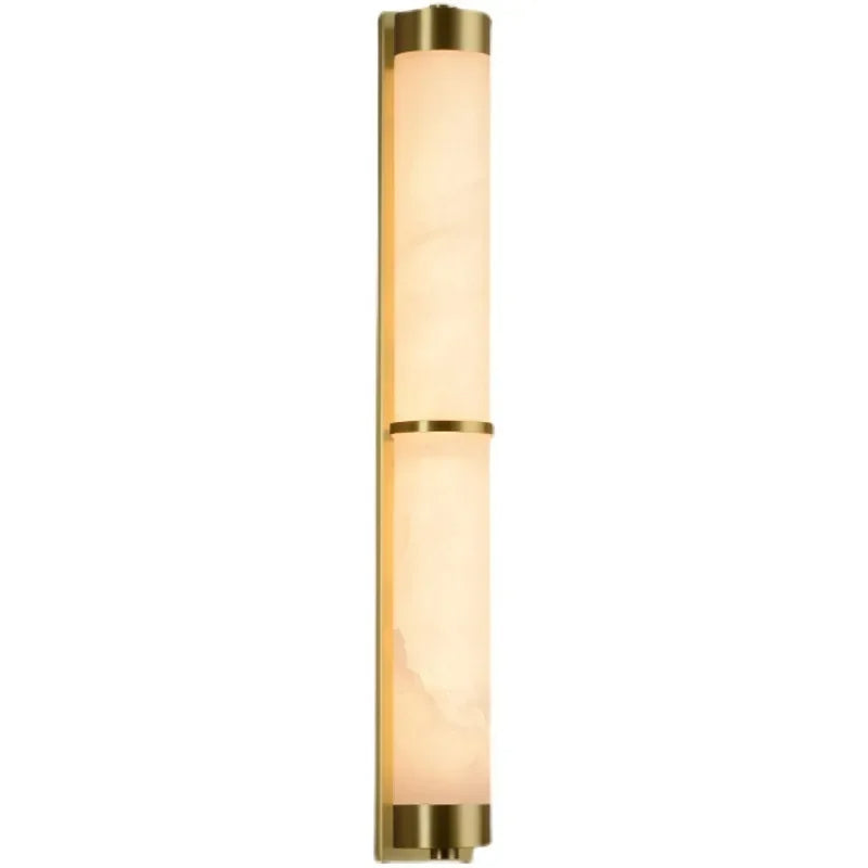 A wall-mounted light fixture with a long, cylindrical design. It combines a gold metal frame with two frosted, white glass sections that diffuse the light. Oriented vertically, this 23" Natural Marble & Brass Wall Light by Morsale offers a modern, sleek appearance and exemplifies sustainable luxury.