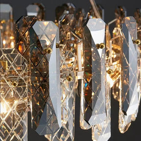 A close-up of the Lazzo Crystal Ceiling Chandelier by Morsale.com features angular, handmade crystals intricately arranged and illuminated by warm light bulbs behind them, casting a radiant glow. The crystals are mounted on gold-plated stainless steel fixtures, enhancing the elegance of the design.