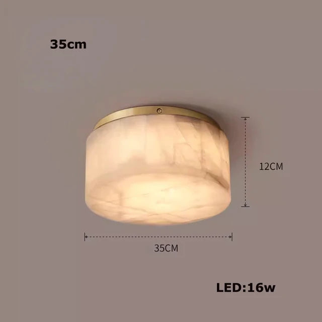 The Moonshade Natural Marble Ceiling Light Fixture by Morsale.com features a 35 cm diameter and a 12 cm height, boasting a polished finish. This elegant light uses an energy-efficient 16W LED bulb and includes the option of a gold or brass accent ring at the top of the fixture. All dimensions and specifications are clearly labeled around the light.