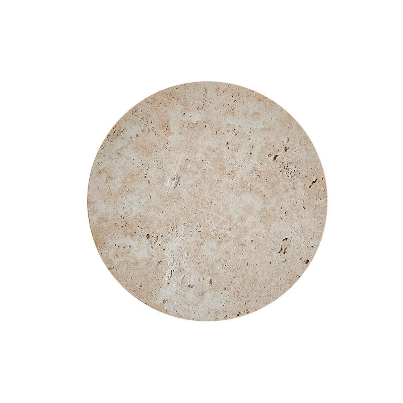 A circular, tan-colored stone Natural Travertine Wall Sconce by Morsale.com with a slightly textured surface, displaying natural variations in color and small porous details. Reminiscent of handmade wall sconces, the wall sconce is photographed against a plain white background.