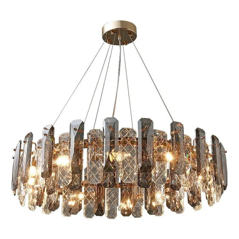 The Morsale.com Lazzo Crystal Ceiling Chandelier with a circular design features numerous vertical, crystal-like glass pieces arranged around its perimeter. Each piece is intricately textured, emitting a warm, inviting light from multiple bulbs inside. Thin wires suspend it from a golden base, enhanced by LED illumination.