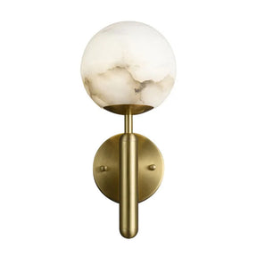 Modern wall sconce with a brass cylindrical base and a round frosted glass shade. The design features subtle marble-like accents in the glass, creating a sophisticated and elegant look, reminiscent of the Natural Marble Sphere Wall Sconce by Morsale.com. The fixture is mounted on a round brass backplate.