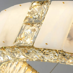 A close-up image of a Natural Marble & Crystal Modern Ceiling Light Fixture by Morsale.com, featuring large, square-cut crystals and frosted glass panels, all mounted on a gleaming gold frame. This modern ceiling light fixture's intricate design and sparkling accents exude an air of elegance and sophistication. Perfect for any luxury home décor.