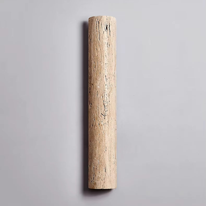 The IP65 Waterproof Natural Travertine Wall Light by Morsale features a sleek, cylindrical design with elegant natural textures, beautifully enhanced by LED illumination and set against a plain, light gray backdrop.