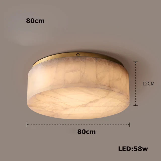 The Moonshade Natural Marble Ceiling Light Fixture by Morsale.com is a round, flush-mount ceiling light with an alabaster finish. It measures 80 cm in diameter and 12 cm in height, featuring energy-efficient LED lights that consume 58 watts of power. This fixture provides a soft, warm glow and has a smooth, wide cylindrical shape.