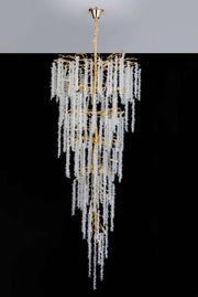The Albero Crystal Foyer Chandelier by Morsale.com is a breathtaking and extravagant piece, featuring numerous cascading strands of sparkling crystals that create a delicate, waterfall-like effect. Its polished gold frame adds an opulent touch to its elegant and luxurious design.