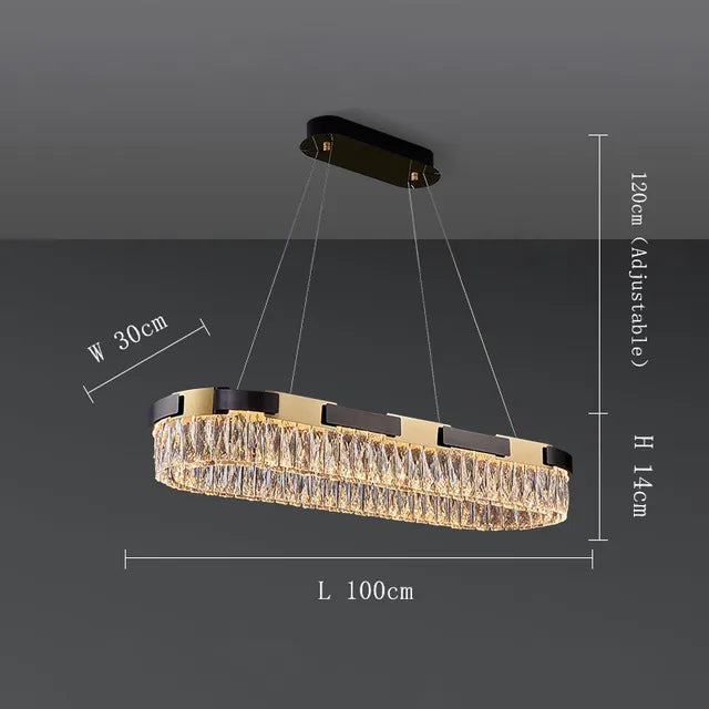 The Siena Contemporary Crystal Light Fixture by Morsale.com is a luxurious rectangular pendant mount chandelier with dimensions of 100 cm in length, 30 cm in width, and 14 cm in height. It features an adjustable hanging length of up to 120 cm, suspended by four wires from a brass-toned frame.