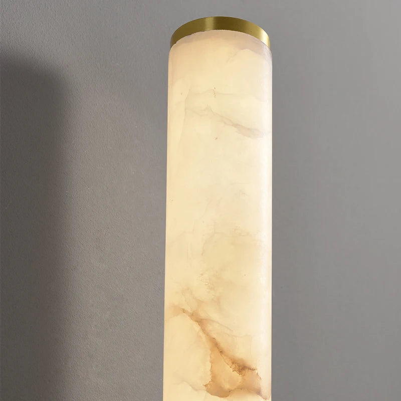 This close-up showcases the Morsale 27" Moonshade Natural Marble & Copper Wall Sconce, featuring a stunning marbled finish accented with a copper rim at the top. Illuminated by advanced LED technology against a gray backdrop, it’s perfect for adding elegance to any room.