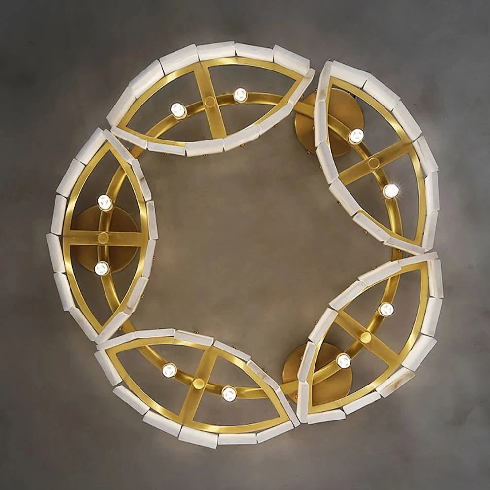 An overhead view of a Natural Marble Modern Chandelier Light by Morsale.com featuring a circular design made up of gold-colored segments and white accents. The light bulbs are integrated within the segments. The text on the image reads "Dia85*H22.5cm LOOK UP EFFECT." The background is a grayish surface, perfect for luxury home decor.