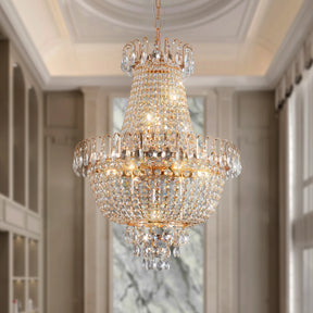 The Morsale French Empire Crystal Chandelier, an elegant piece with halogen bulbs, hangs from a high ceiling in a sophisticated room. Its crystal decorations cast a warm glow as they reflect light beautifully.